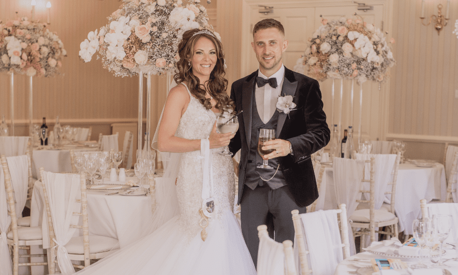 Bride and groom posing together in their wedding breakfast room at De Courceys, celebrating their just-married moment in a beautifully decorated venue.