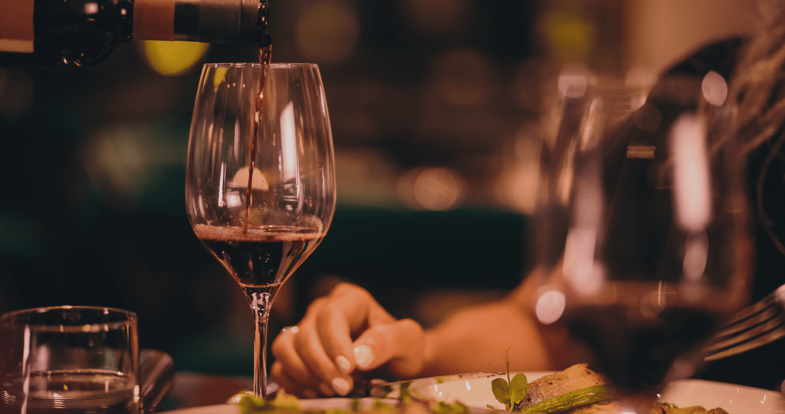 Elegant private dining setup featuring red wine glasses on a refined table, perfect for business meetings or intimate gatherings.