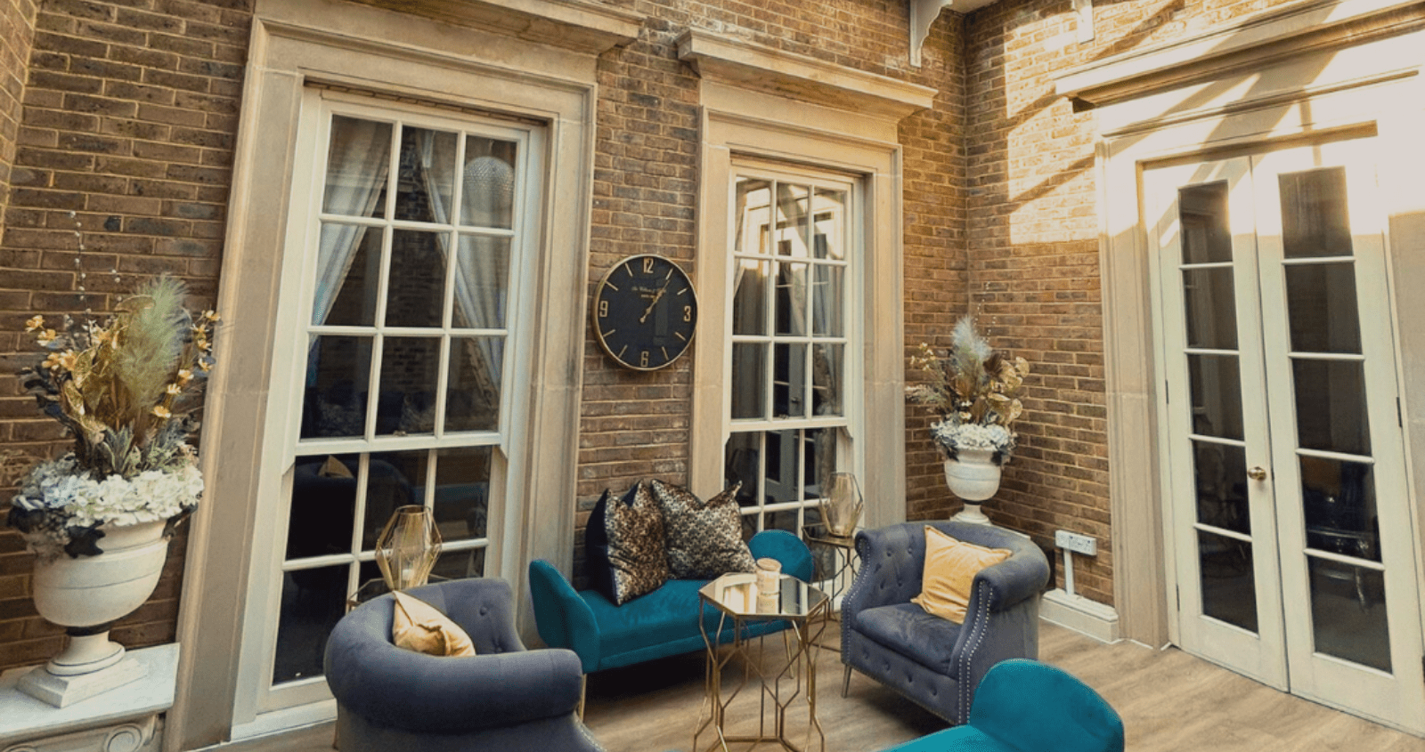 Elegant internal room at De Courceys Manor featuring a stunning glass-ceiling atrium, allowing natural light to flood the stylish space.