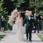 Bride and groom exchanged their vows in an outdoor secret garden civil ceremony, beautifully framed by a lush woodland backdrop.