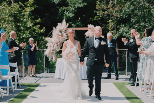 Bride and groom exchanged their vows in an outdoor secret garden civil ceremony, beautifully framed by a lush woodland backdrop.