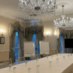 Board style room with flip charts and meeting setup for floral suite